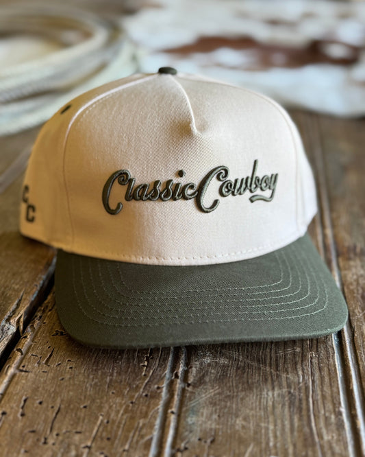 Beige and green cap with 'Classic Cowboy' text on a wooden surface