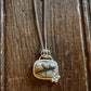 Necklace with a pendant on a wooden surface