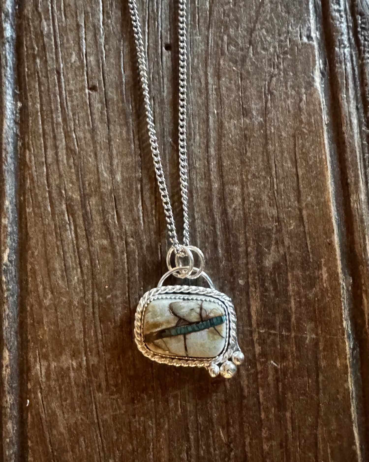 Necklace with a pendant on a wooden surface