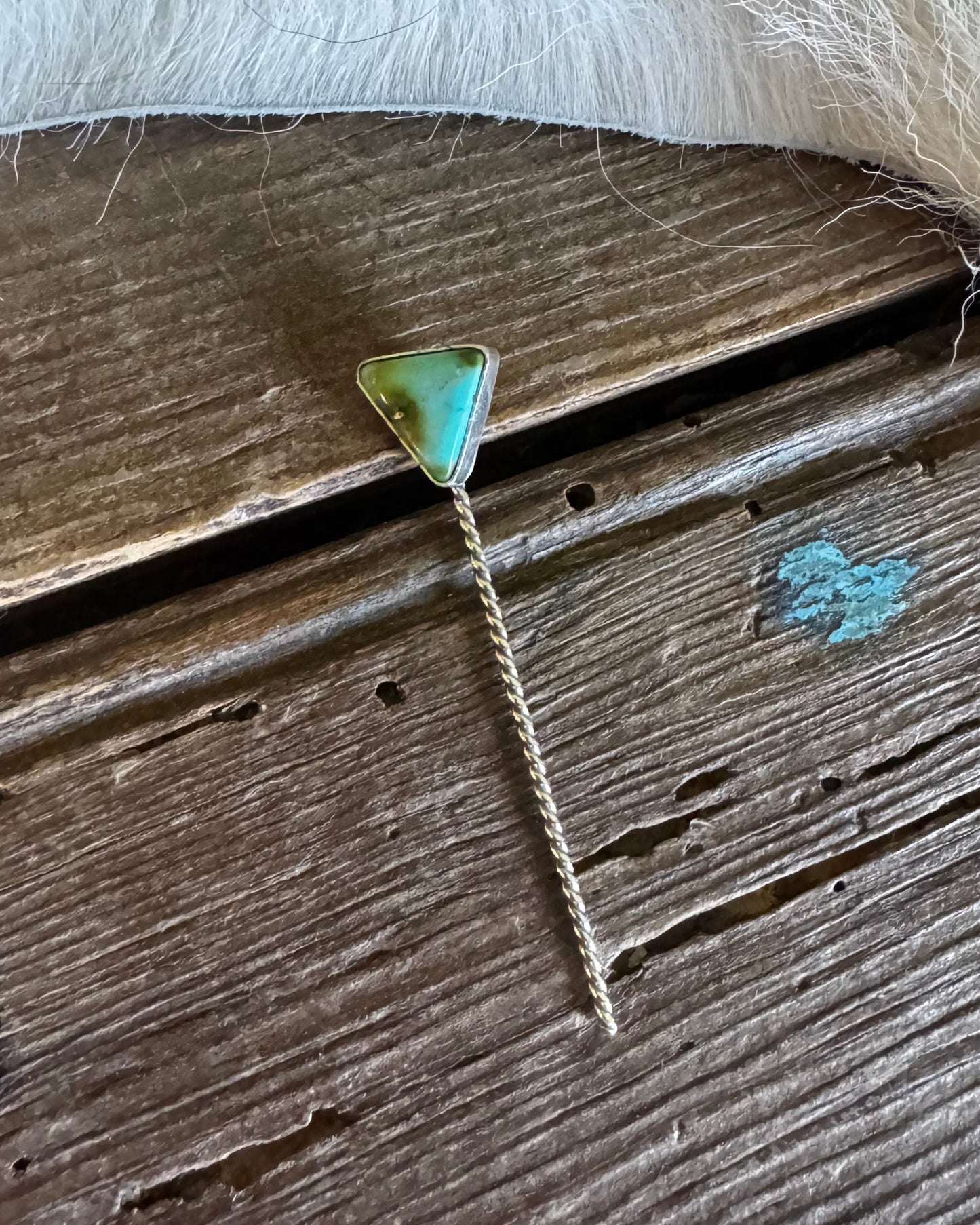 Necklace with a green pendant on a wooden surface