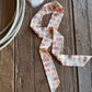 horse ribbon scarf on rustic wood background with lariat rope