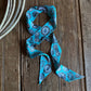 Blue patterned ribbon scarf on a wooden surface