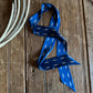 Blue ribbon scarf and white rope on a wooden surface