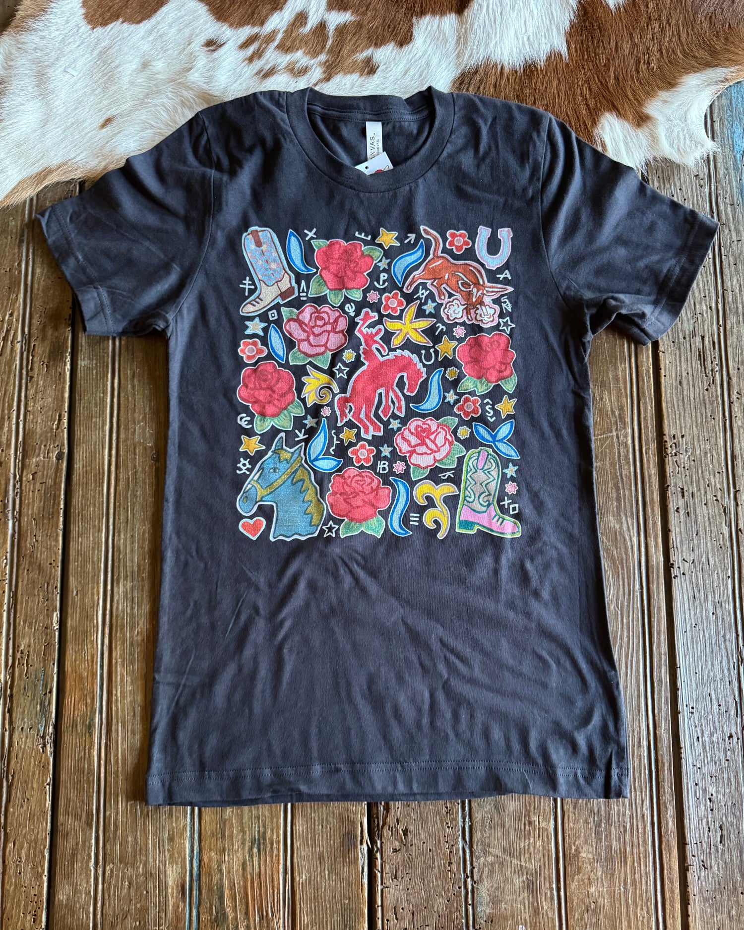 Western Rose Ranch Graphic tee on rustic wood background 