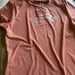 Pink t-shirt with 'Ranch Girls' logo on a textured surface