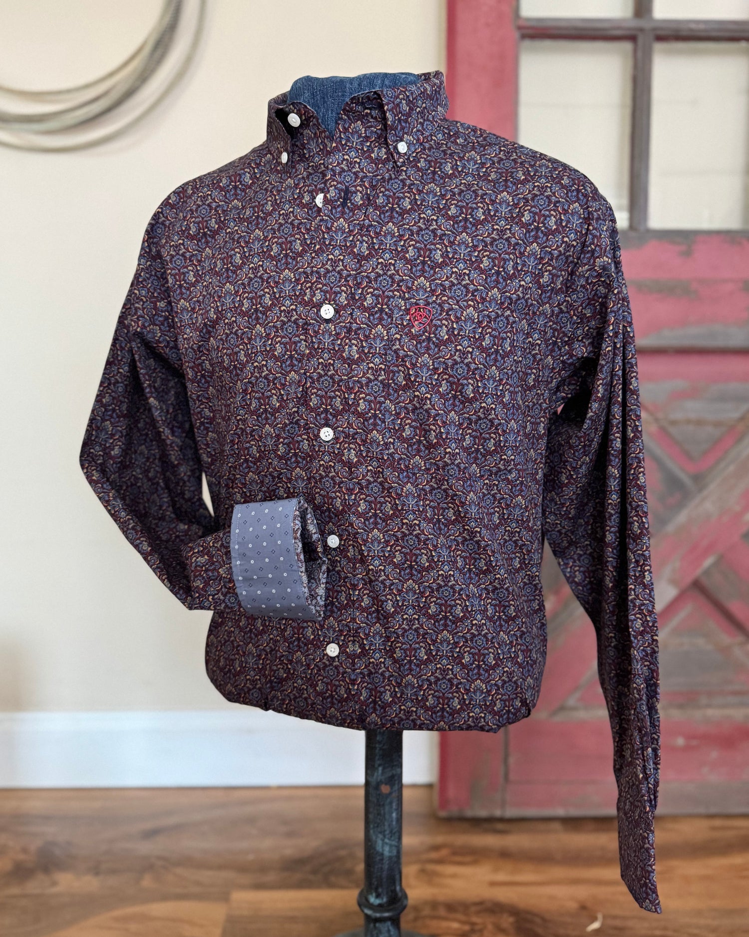 Shirt on a mannequin with a rope and rustic wall background