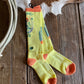 Colorful sock with abstract design on a wooden surface