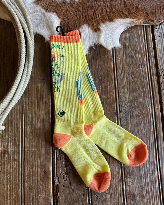 Colorful sock with abstract design on a wooden surface