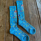 Shine Like a Star Performance Socks in turquoise on rustic wood background 