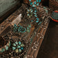 Close-up of silver and turquoise jewelry on a dark surface