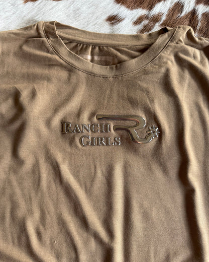 Brown t-shirt with a logo on a cowhide background