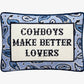 Decorative pillow with text 'Cowboys Make Better Lovers' on a blue patterned background