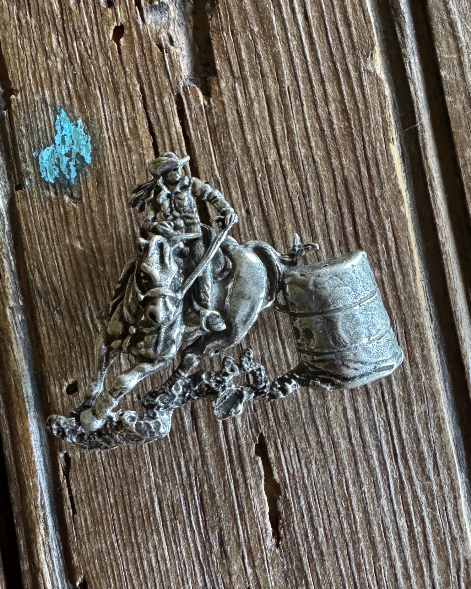barrel racer pin on wooden background 