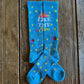 Shine Like a Star Performance Socks in turquoise showing design on rustic wood background 