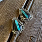 Turquoise stone hair pins on a wooden surface