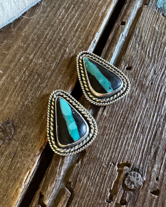 Turquoise stone hair pins on a wooden surface