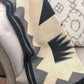 Textured blanket with geometric pattern draped over a surface