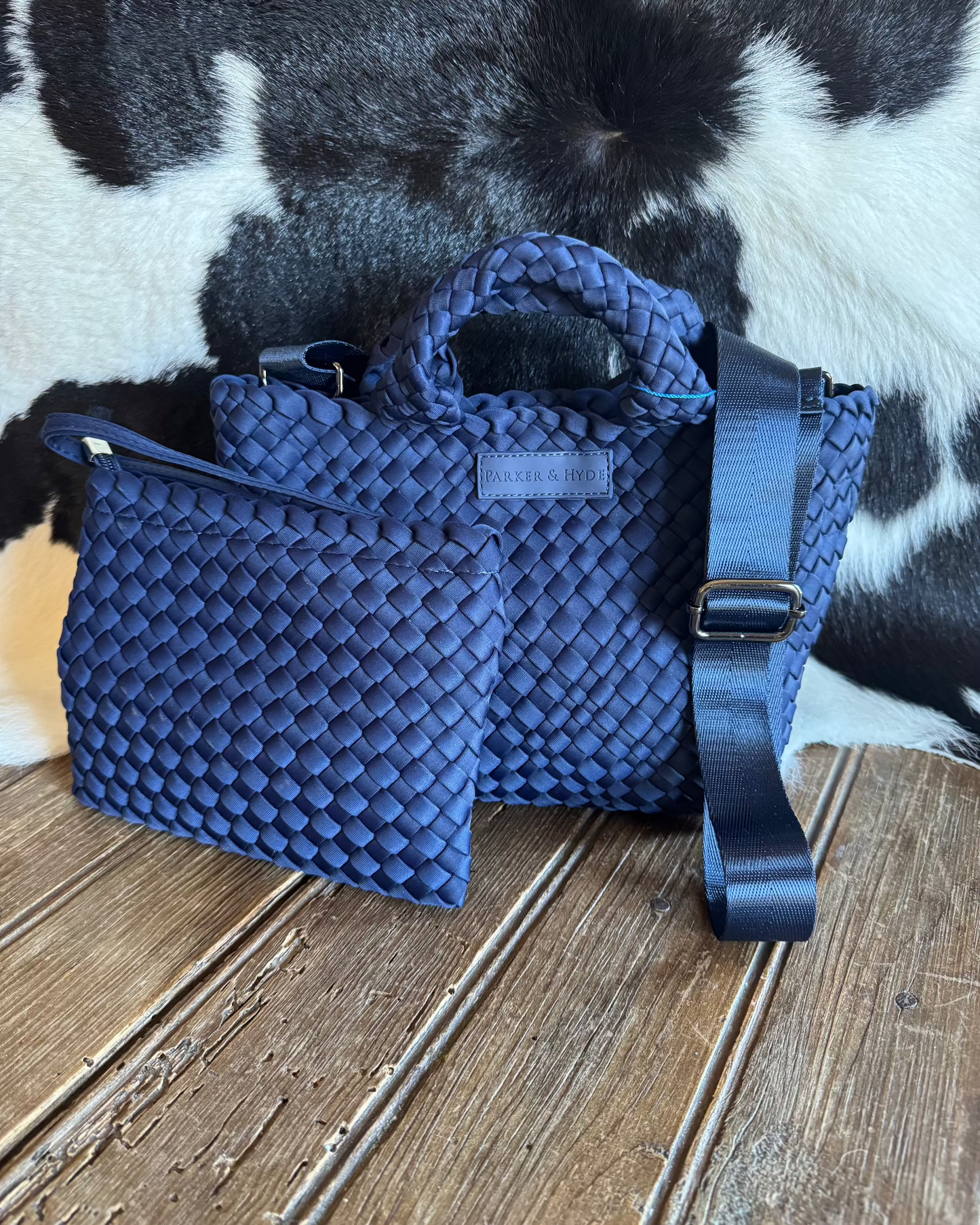 woven handbag and wristlet with cowhide background