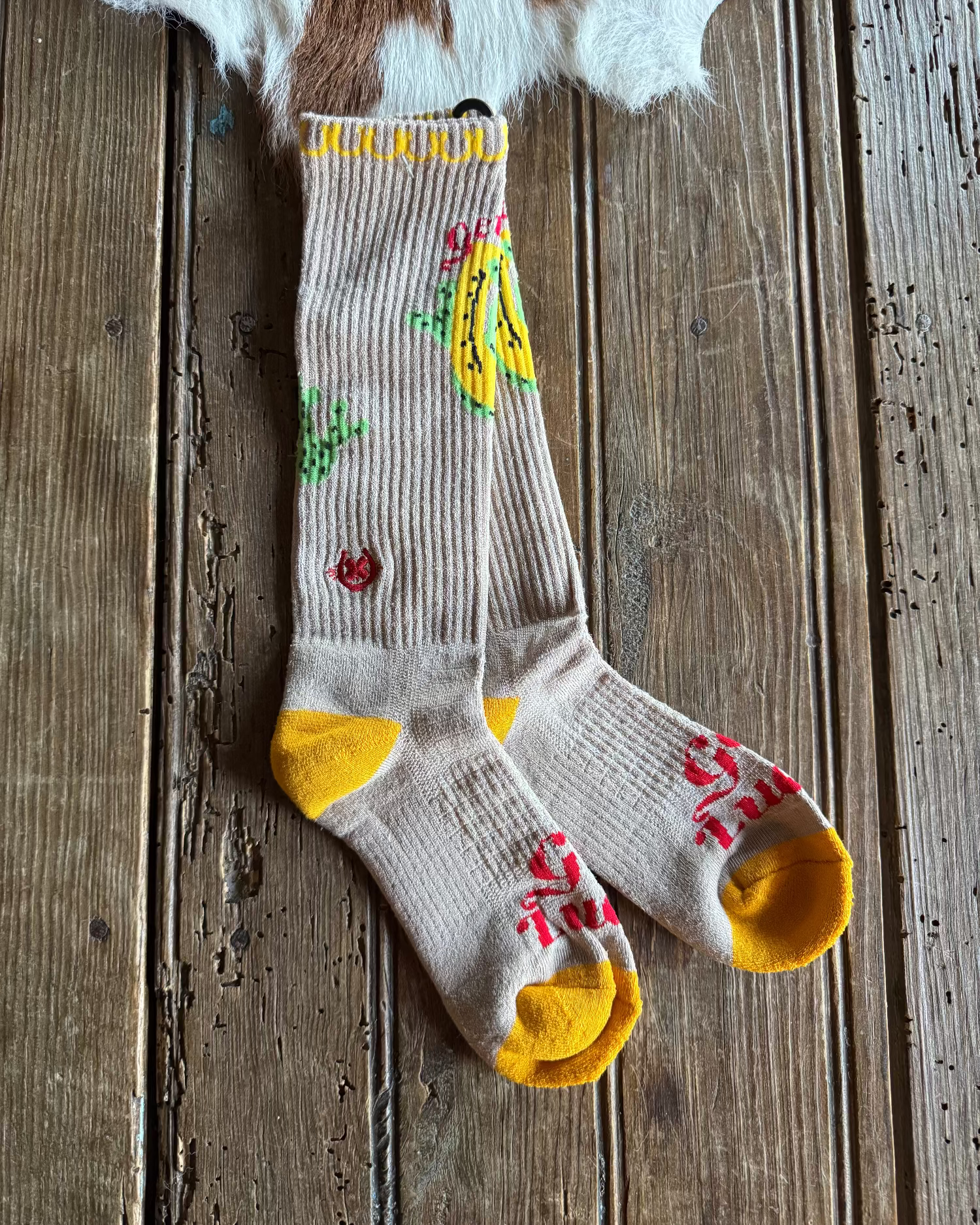 Sock with banana design on a wooden surface