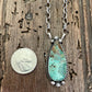 Close up of Kingman Turquoise teardrop necklace with quarter for size comparison